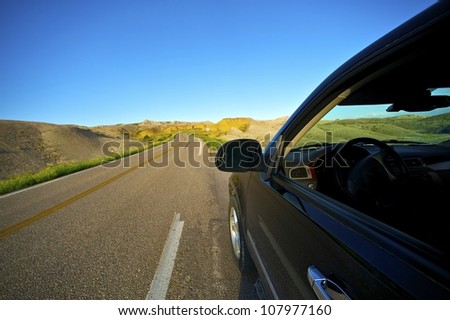 Badlands Drive Thru. Traveling Theme with Black SUV on the Loop Road in Badlands National Park, South Dakota, USA.