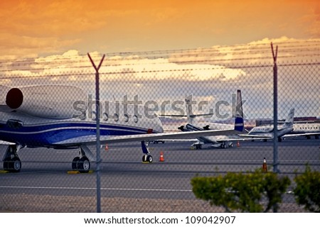 Airport with Small Jet Planes. Air Transportation Theme. Airport Fence.