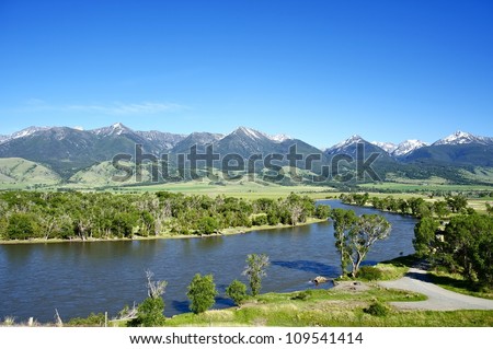 Yellowstone River Near Livingston, Montana, U.S.A. Montana Landscape with Yellowstone River, Mountains Range with Snowy Peaks and Clear Blue Sky. Nature Photo Collection.