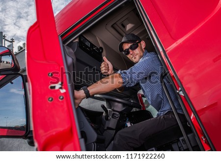 Happy Caucasian Semi Truck Driver Showing Thumb Up. Trucking Theme. Transport Industry.