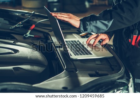 Vehicle Computer Checkup and Engine Software Update by Professional Auto Service Technician. Computerized Automotive Systems.