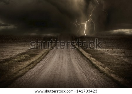 Stormy Back Country Road. Heavy Storm and Lightning Bolt in a Distans. Severe Weather Imagery Collection.