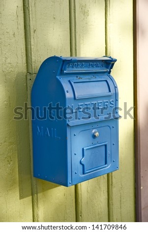 Blue Vintage U.S. Mailbox on the Wall. Postal Letters Box