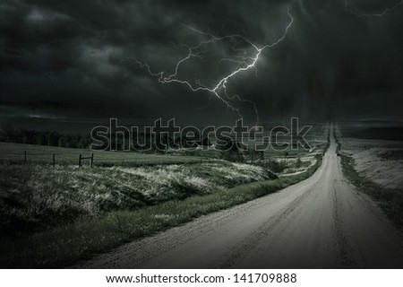 Country Storm. Back Country Gravel Road and Storm Ahead. Lightning Bolt in a Distance. Severe Weather Collection.