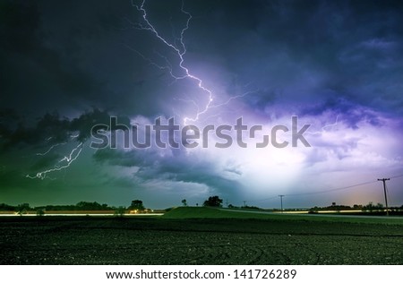 Tornado Alley Severe Storm at Night Time. Severe Lightnings Above Farmlands in Illinois, USA. Severe Weather Photography Collection.