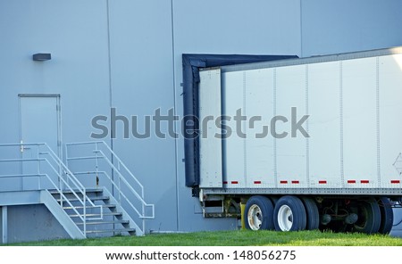 Semi Truck Delivery. Truck Trailer in Warehouse Dock.