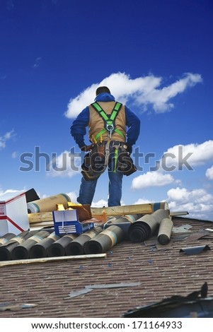 Roofing Contractor on the Roof Repairing. Contractor Repairing Damage to Shingles. Roofing Works