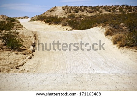 Sandy Desert Road in Mojave Desert, California, United States. Back Country Bumpy Road.