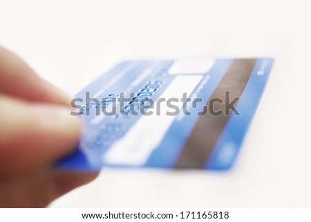Magnetic Bank Credit Card In A Hand Isolated On White. Credit Card Reverse.