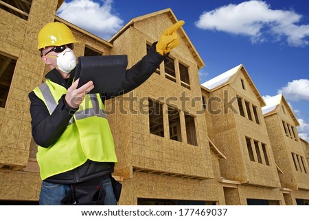 Construction Engineer on Construction Site. Contractor with Tablet Point on Something.
