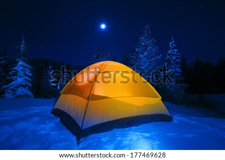 Winter Tent Camping in Colorado Wilderness. Cold Snowy High Country Night in Small Orange Tent.