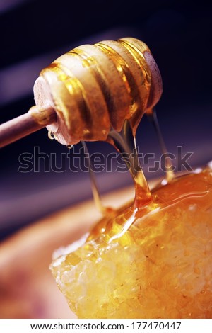 Raw Honey and Honey Dipper Closeup. Sweet Raw Honey Dessert.