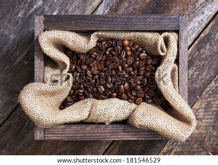 Coffee in a Small Wood Crate on Aged Wood Table.
