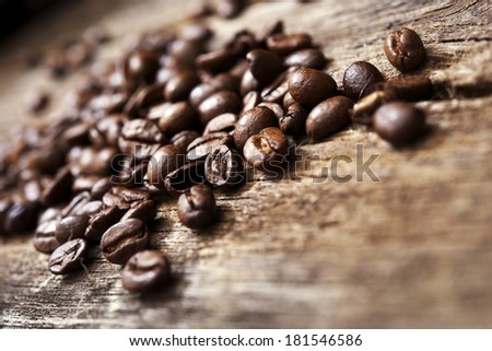 Coffee Beans on Aged Wood Table Closeup.
