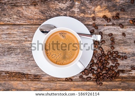 Coffee in White Cup Top View. Reclaimed Wood Table Background.