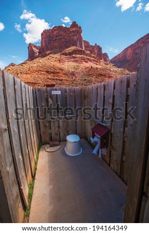 Scenic Primitive Restroom with the View. Simple Wood Wall Camping Restroom Between Scenic Rock Formations.
