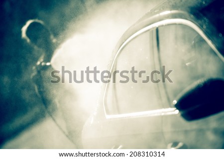 Woman Cleaning Modern Car Using High Pressure Water Sprayer.