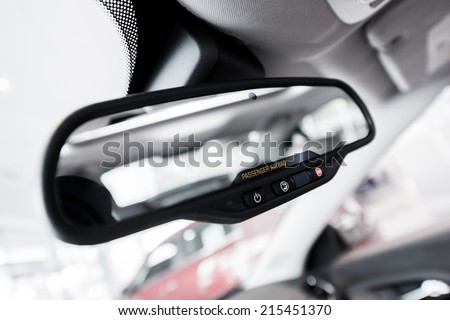 Rear View Interior Car Mirror with Safety Buttons and Passenger Airbag Indicator Closeup.