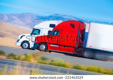Two Speeding Semi Trucks on the Nevada Highway, USA. Trucking in America.