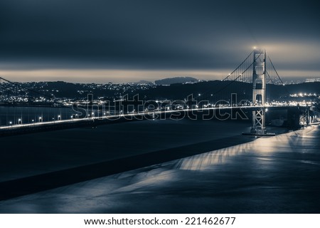 Golden Gate Night Theme. Golden Gate Bridge and San Francisco Panorama in Dark Blue Color Grading.