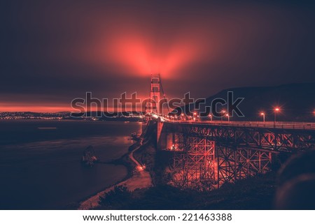 San Francisco Bay and th Golden Gate Bridge in the Fog. Night Panorama with Reddish Color Grading.