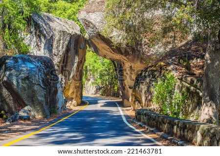 Natural Stone Bridge and the Road Through Sierra Nevada Mountains in California.