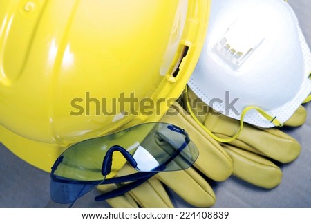 Safety Protective Work Equipment. Yellow Helmet, Glasses, Gloves and Mask. Protection Gear Closeup.
