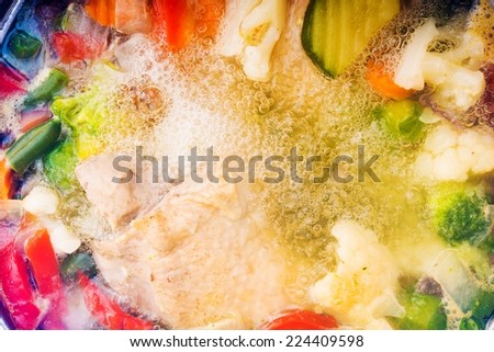 Colorful Full of Vegetables Chicken Noodle Soup Cooking. Boiling Noodle Soup Closeup.