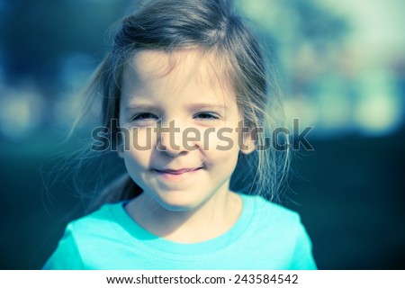 Cute Little Girl Outdoor Portrait in the Summer Light. Cool Blue Color Grading. Happy Children Portrait.