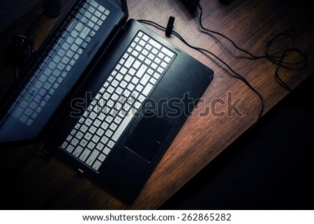 Modern Laptop on the Wooden Desk. Working at Night Theme.