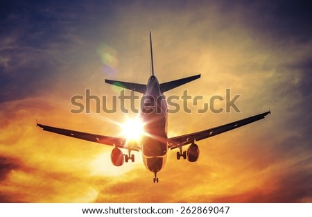 Landing Airplane and the Sun. Air Travel and Transportation Photography Concept.