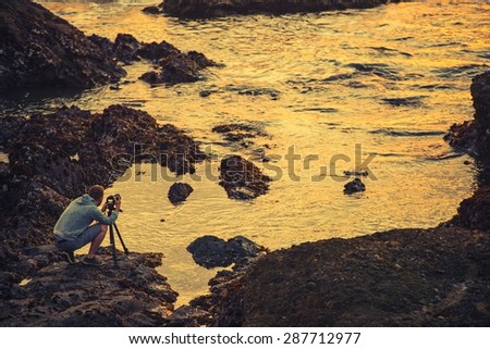 Nature Photographer Taking Ocean Sunset Pictures. Nature Photography. California Coast, United States.