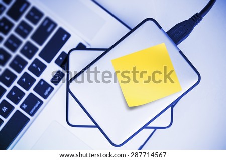External Hard Drives Backup For Laptop. Small Portable Hard Drive with Yellow Sticky Paper Note. Mobile Workstation.