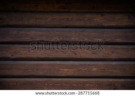 Dark Wood Logs Wall Photo Background. Log Home Wall Closeup.