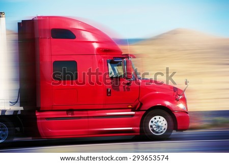 Red Semi Truck on the Road. Semi Truck Tractor Closeup. American Road Transportation.