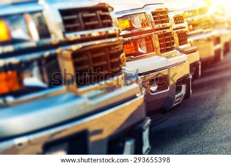 Car Sales Business Photo Concept. Row of Brand New Vehicles For Sale at Dealer Parking Lot. American Car Sale Business.