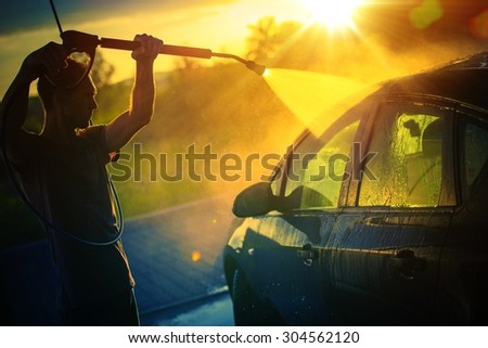 Vehicle Washing at Sunset, Hot Summer Afternoon Car Washing. High Pressure Water Washing.