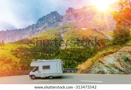 Camper Mountain Trip. Class C Camper Van on a Summer Mountain Road. Camper Journey.