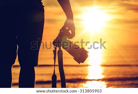 Sunset Photography. Photographer Ready to Take Sunset Pictures on the Beach. Professional Travel Photography Works.