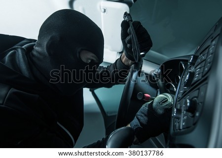 Vehicle Thief Concept Photo. Caucasian Car Thief in Black Mask.