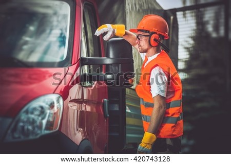 Worker and His Truck. Hard Working Men Wearing Construction Safety Accessories.