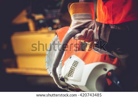 Stone Cutter Works. Construction Worker with heavy Duty Cutter.