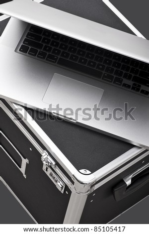 Modern Laptop Computer on Black Production / Equipment Case. Top View. Vertical Photo.