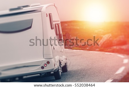 Camper RV Sunset Trip. Motorhome Summer Journey. Class C Recreational Vehicle on the Road