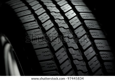 Car Tire on Black Background. Car Tire in the Dark - Spot Light