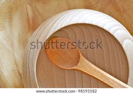 Wood Bowl on the Wood Table. Wood Spoon Inside. Wooden Cooking Theme. Wood Bowl Top View Photo.