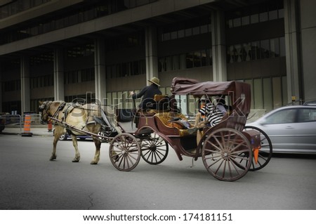 QUEBEC, CANADA - AUG 21th, 2009 :illustrative picture of a family traveling in horse carriage on the of old Quebec city, Canada