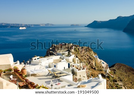 scenic view of a patio over the caldera on Aegean sea  in Oia village with a resting dog