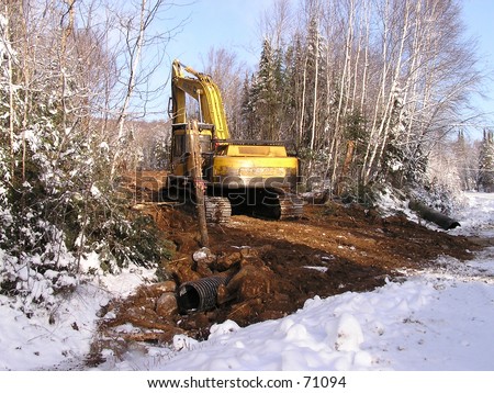 bulldozer on construction road  in a forest of Quebec