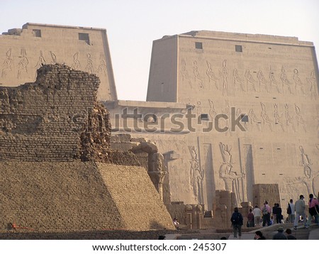 Tourists visiting the Edfu cult  Temple dedicated to god Horus, shown all over the place as a human body with a falcon head.